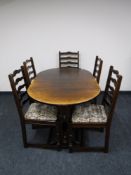 An oak extending dining table and five ladder back chairs