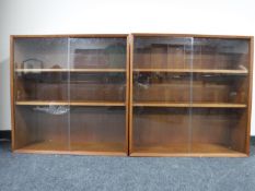 Two teak sliding door bookcases