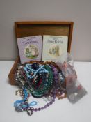 A wooden box of costume jewellery, beads, necklaces, etc,