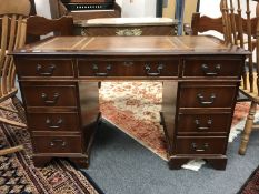 A Victorian style mahogany pedestal desk with inset brown leather top
