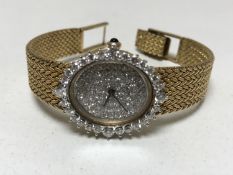 An 18ct gold lady's cocktail wristwatch with diamond set case and dial