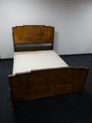 An early 20th century walnut bed frame