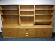 A mid twentieth century light oak three part bookcase,