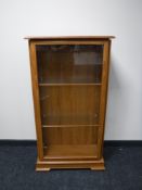 A light oak display cabinet