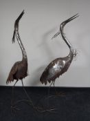 A set of four metal garden stork figures