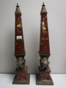 A pair of ornate ormolu mounted obelisks decorated with figures of elephants