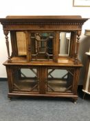 A Victorian oak display cabinet with mirror panelled back