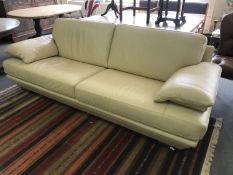 A cream leather three seater settee CONDITION REPORT: Some minor scuffs but overall