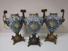 A trio of ormolu mounted blue and white decorative urns