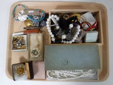 A large tray of costume jewellery, beaded necklaces,