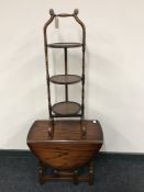 A mahogany cake stand together with a small oak gateleg table