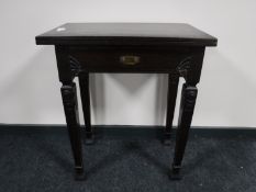 A carved oak tea table,