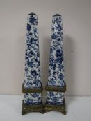 A pair of ormolu mounted blue and white obelisks
