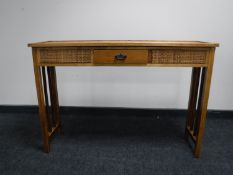 A wicker topped side table fitted a drawer