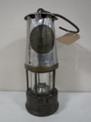 A vintage Protector miner's lamp