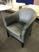 A green leather tub chair