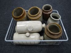 A box of antique stone hot water bottles and stoneware jars