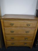 An Edwardian oak four drawer chest