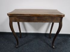 A nineteenth century oak tea table on cabriole legs