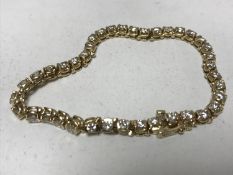 A 14ct gold diamond set tennis bracelet set with thirty-nine diamonds, 16.