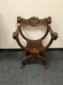 A pair of carved Savonarola armchairs