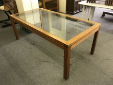 A walnut glass topped low table