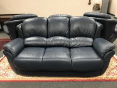 A blue leather four piece lounge suite : three seater settee,