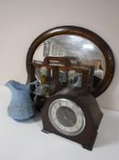 An oak mantel clock together with an Edwardian oak mirror,