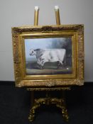 A gilt framed print depicting a bull,