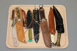A group of modern hunting and military style knives.