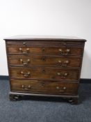 A George III mahogany chest of four drawers, with brushing slide, raised on pierced bracket feet,