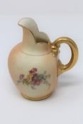 A Royal Worcester blush ivory gilded jug, height 14cm.