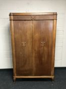 An early 20th century oak double door cabinet fitted with shelves, width 102cm.