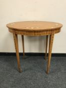 An Edwardian satinwood and polychrome painted oval occasional table, on tapered legs, width 74 cm.