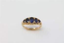 An 18ct gold five stone sapphire ring, size K, 2.9g.