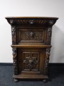 A 19th century carved oak cabinet, fitted two cupboards and a drawer, width 71cm.