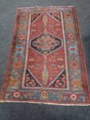 A Kazak rug, a geometric medallion upon a strawberry field,