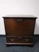 A George III oak chest fitted a drawer, raised on bracket feet, width 66cm.
