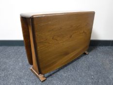 An Ercol elm drop leaf gateleg coffee table, width 102cm opened.