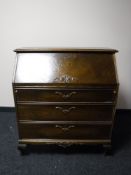 A continental oak bureau fitted with three drawers, width 89cm.
