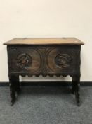 A 17th century style oak coffer on stand, width 83 cm.