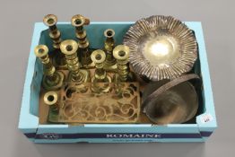 A box containing Victorian brass candlesticks, brass jam pan, trivet stand etc.