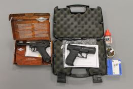 A boxed CO2 powered German Luger .177 air pistol, together with a boxed Umarex .177 air pistol.