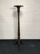A Georgian style carved mahogany torchere, height 152cm.
