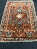 A Persian rug, a large central geometric medallion upon a brick ground,
