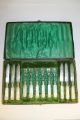 A cased set of twelve E.P.N.S. dessert knives and forks with mother of pearl handles.
