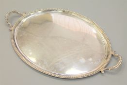 A fine quality Victorian oval silver twin-handled serving tray, maker A M, London 1865, width 62cm,