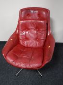 A mid 20th century red leather swivel relaxer chair, width 77cm.
