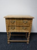 A light oak two drawer side table, width 55cm.