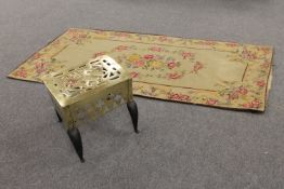An early 19th century brass footman, together with a 19th century French abousson rug.
